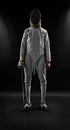 Male fencer standing on black background