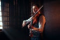 Male fiddler playing classical music on violin