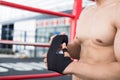 male fighter wear bandages on fist. muscular man bind bandage on