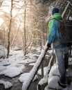 Male figure standing on the snow covered stairs in the forest, exploring Royalty Free Stock Photo