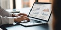 Male financial analyst in eyeglasses works in front of a laptop monitor. Royalty Free Stock Photo