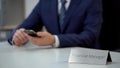 Male financial manager using mobile app on smartphone, viewing e-documents Royalty Free Stock Photo