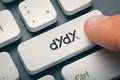 Finger pressing computer key with dydx token logo. crypto mining concept