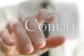 Male finger pressing Contact button on a touch screen interface Royalty Free Stock Photo