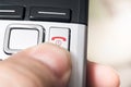 Male Finger On The Red Hang Up Button Of A Wireless DECT Telefphone, Ready To End The Call Royalty Free Stock Photo