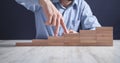 Male fingers climbing stairs on wooden blocks