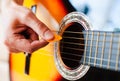 Male fingers with mediator playing on guitar strings. Close-up Royalty Free Stock Photo