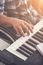 Male fingers playing the electric piano