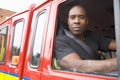 Male firefighter sitting in the cab