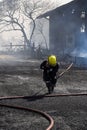 Male firefighter spraying high pressure water