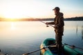 Male fisherman at dawn on the lake catches a fishing rod. Fishing hobby vacation concept. Copy space