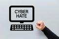 Male fist with a computer icon with cyber hate written on the screen. Harassment, racism, intimidation and humiliation in cyber