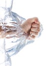 A male fist is smashing the water with waves and bubbles. Isolated on white background Royalty Free Stock Photo