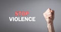 Male fist. Stop Violence text on gray background