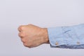 Male fist on a white background close up. Aggression, brave, courage concepts