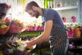 Male florist arranging bouquet of flower at flower shop