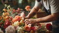 Male florist creating bouquet in flower shop, close up. Man is creating a bouquet