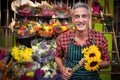 Male florist holding bunch of flowers at flower shop Royalty Free Stock Photo