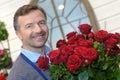 Male florist holding bunch roses Royalty Free Stock Photo