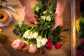 Male florist preparing flower bouquet