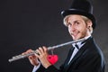Male flutist with flute and heart. Love melody Royalty Free Stock Photo