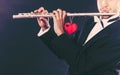 Male flutist with flute and heart. Love melody Royalty Free Stock Photo