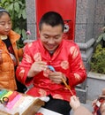 Male folk artist make traditional chinese dough doll