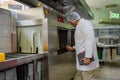 Man food inspector in uniform checks the kitchen of the restaurant