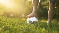 Male foot without shoes on a soccer ball on a grassy field with a sun glare and a copy space. Royalty Free Stock Photo