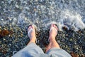 Male foots in shales in transparent sea water Royalty Free Stock Photo