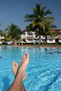 Male foots and swimming pool Royalty Free Stock Photo