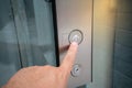 Male forefinger pressing on button up in front of the elevator Royalty Free Stock Photo