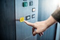 Male hand pressing on emergency button in elevator Royalty Free Stock Photo