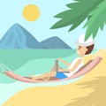 Male freelancer in the hammock on the beach