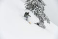 Male freerider with go-pro camera on his helmet sliding down snow covered slope. Royalty Free Stock Photo