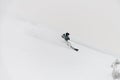 Male freerider skier riding down on snow-covered mountain slope and splash of snow around him. Royalty Free Stock Photo