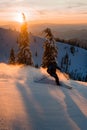 Male freerider speedly ride down snow-covered slopes on fresh powder snow Royalty Free Stock Photo