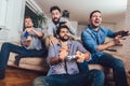 Male friends playing video games at home Royalty Free Stock Photo