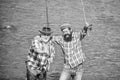 Male friendship. Father and son fishing. Summer weekend. Fishing together. Men stand in water. Nice catch concept