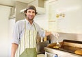 Male fry cook frying a fresh hamburger patty with cheese Royalty Free Stock Photo
