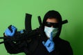 Male gangster or criminal in a medical surgical mask and sunglasses dressed in black clothes Royalty Free Stock Photo