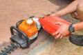 Man fills hedge trimmer with fuel Royalty Free Stock Photo