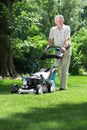 Male gardener mowing Royalty Free Stock Photo