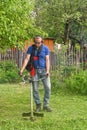 lawn trimming with hand mower. High quality photo Royalty Free Stock Photo