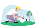 A male gardener waters a small tree from a watering can Royalty Free Stock Photo