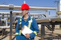 Male gas field operator inspects compressor site