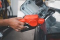 Male gas station attendant refueled car with petrol, refueling car at the refuel station. Concept travel and transportation Royalty Free Stock Photo