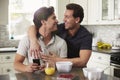 Male gay couple in their 20s embracing in their kitchen Royalty Free Stock Photo