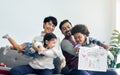 Male gay taking care adopted children who are happy diverse little Caucasian girl and African boy, playing with fun, drawing Royalty Free Stock Photo