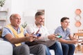 Male generations playing game together Royalty Free Stock Photo